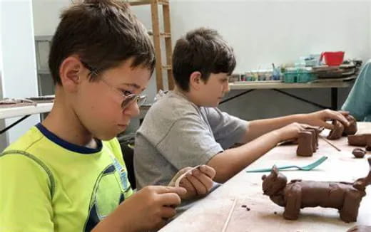 a couple of boys playing with clay