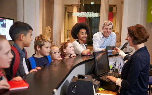 a group of people looking at computers