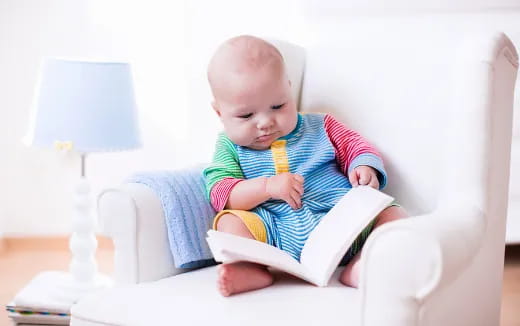 a baby sitting on a chair