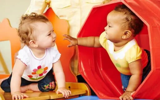 a couple of children sitting in chairs