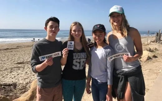 a group of people posing for a photo on a beach