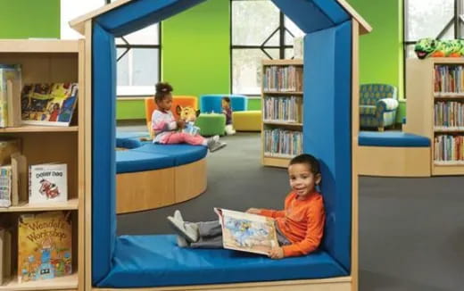 a child and a baby in a room with bookshelves