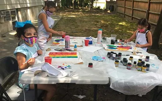 a group of children painting on a table