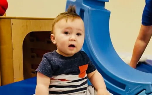 a baby in a blue chair