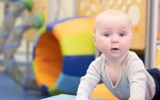 a baby sitting in a chair