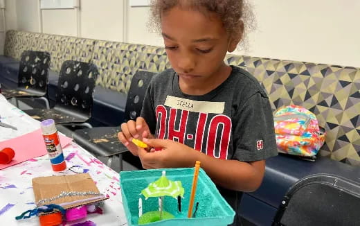 a child painting on a table