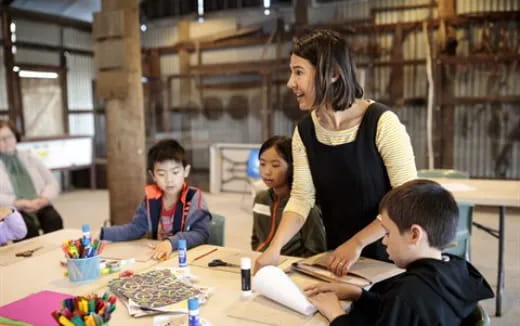 a person teaching a group of children