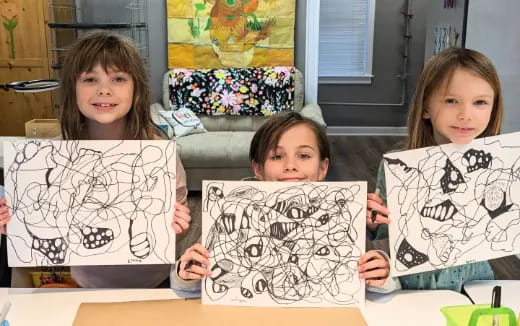 a group of children holding up a piece of paper