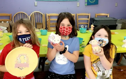 a group of children holding toys