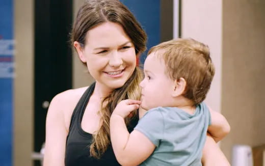 a woman holding a baby