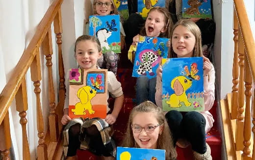a group of children holding books
