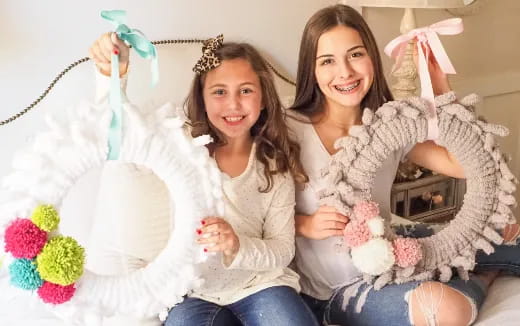 two girls holding a white stuffed animal