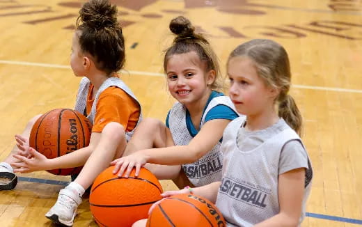 a group of young girls playing basketball