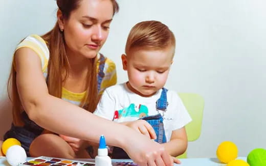 a person and a child looking at a book