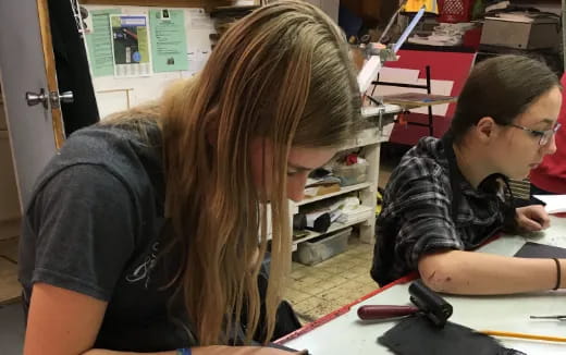 a man and a woman looking at a computer screen