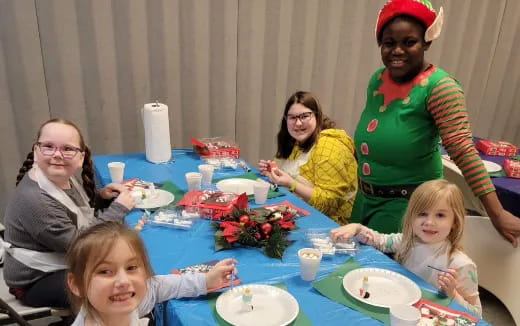 a group of people sitting around a table with food