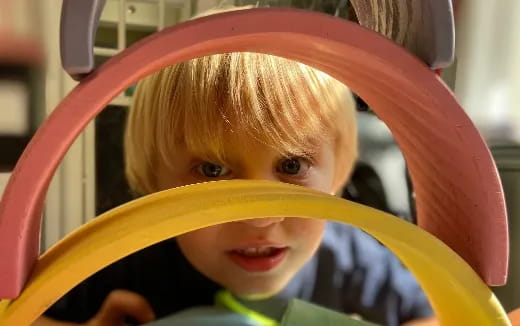 a child in a plastic slide