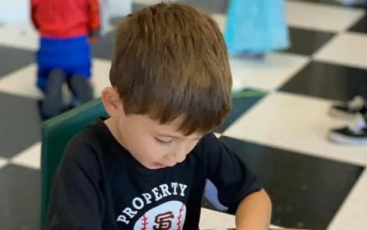a boy sitting at a desk