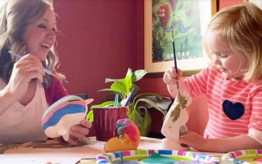 a person and a child painting