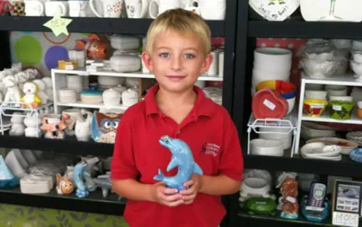 a boy holding a toy