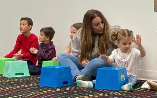 a person and several children sitting on a couch