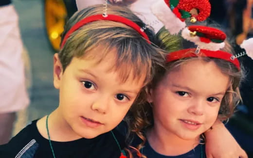 a couple of children wearing red bow ties