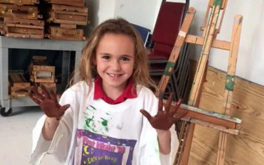 a girl holding a wooden frame