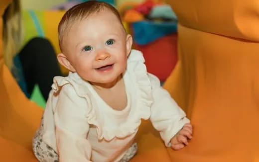 a baby in a white outfit