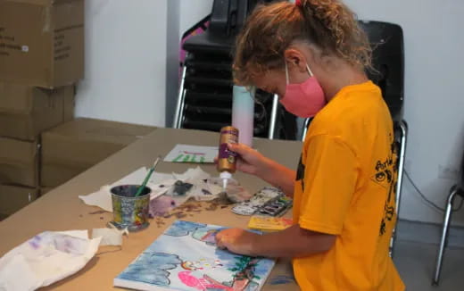 a person painting on a table