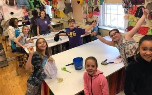 a group of children sitting at a table
