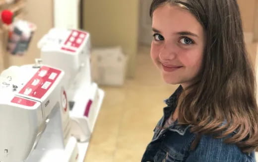 a woman smiling next to a box