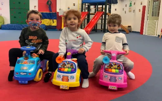 a group of children sitting on toys