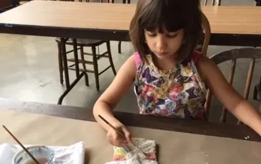a person painting on a table