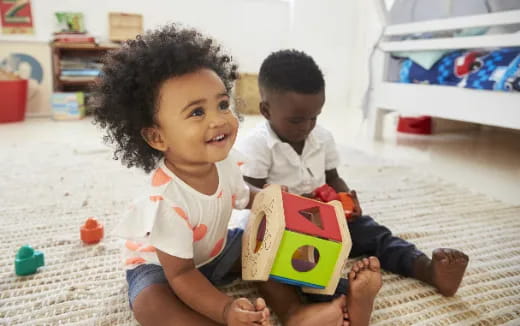 a couple of children playing with a toy