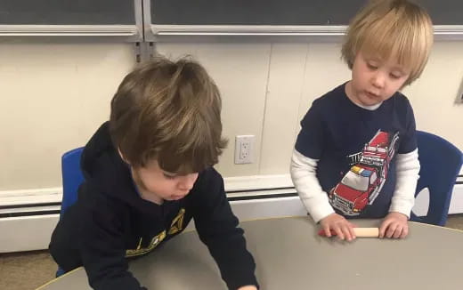 two boys sitting at a table