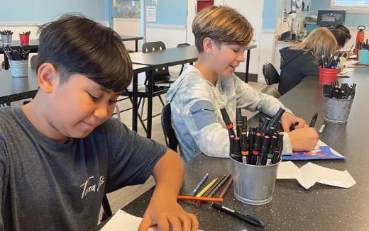 a few young boys working on a project