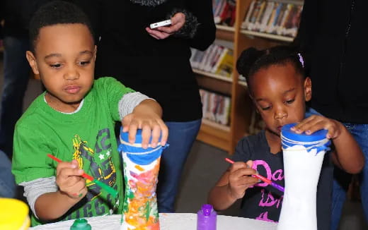 a few children drinking from cups