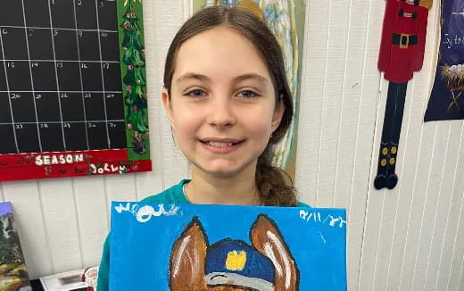a girl holding a blue book
