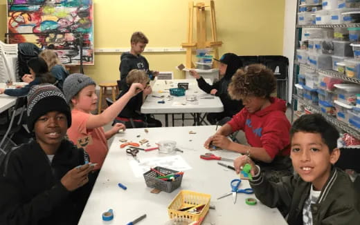a group of children sitting at a table