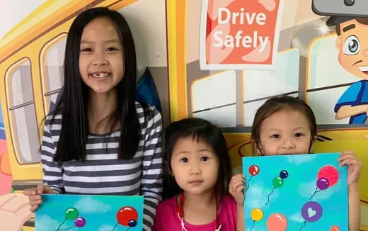 a group of children holding toys