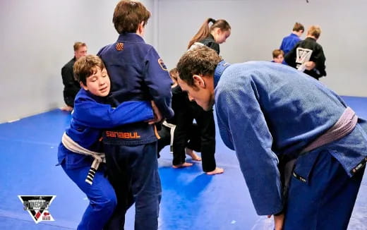 a group of people in blue karate uniforms