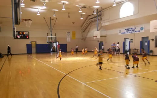 a group of people playing basketball