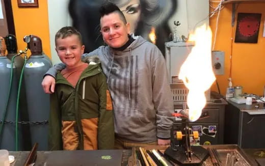 a person and a boy standing next to a machine