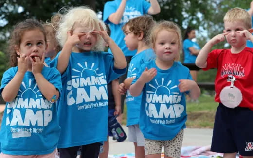 a group of children in blue shirts
