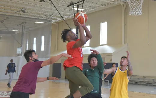 a group of people playing basketball