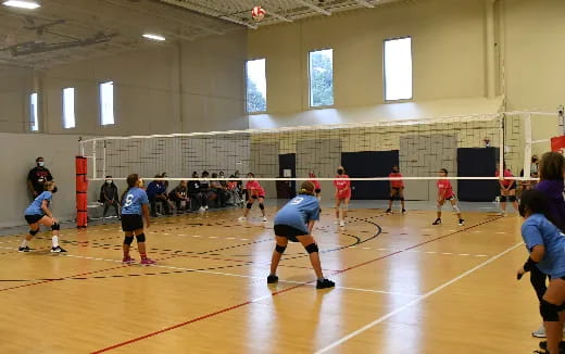 a group of people playing volleyball