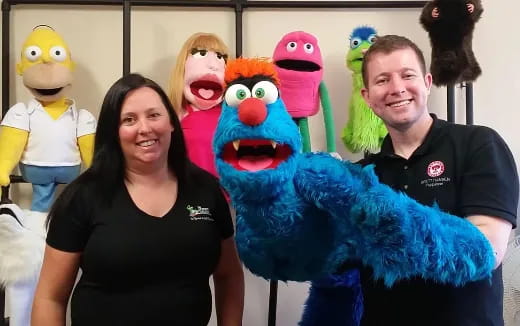 a group of people posing with a person in a garment
