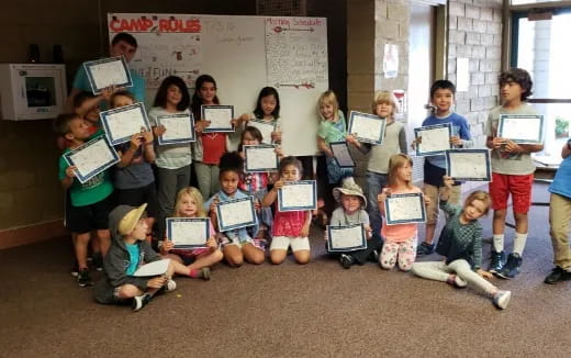 a group of children holding books