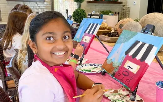 a girl holding a colorful box