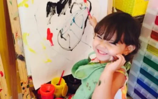 a child drawing on a white board
